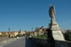 Devotional figure of St Raphael, archangel protector of Cordoba Spain, on Roman bridge over Guadalquivir River.