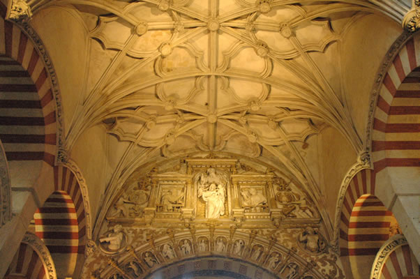 Curious renaissance depiction of Madonna with child in Cordoba Mosque-Cathedral, flanked by Islamic arches and with gothic ceiling.